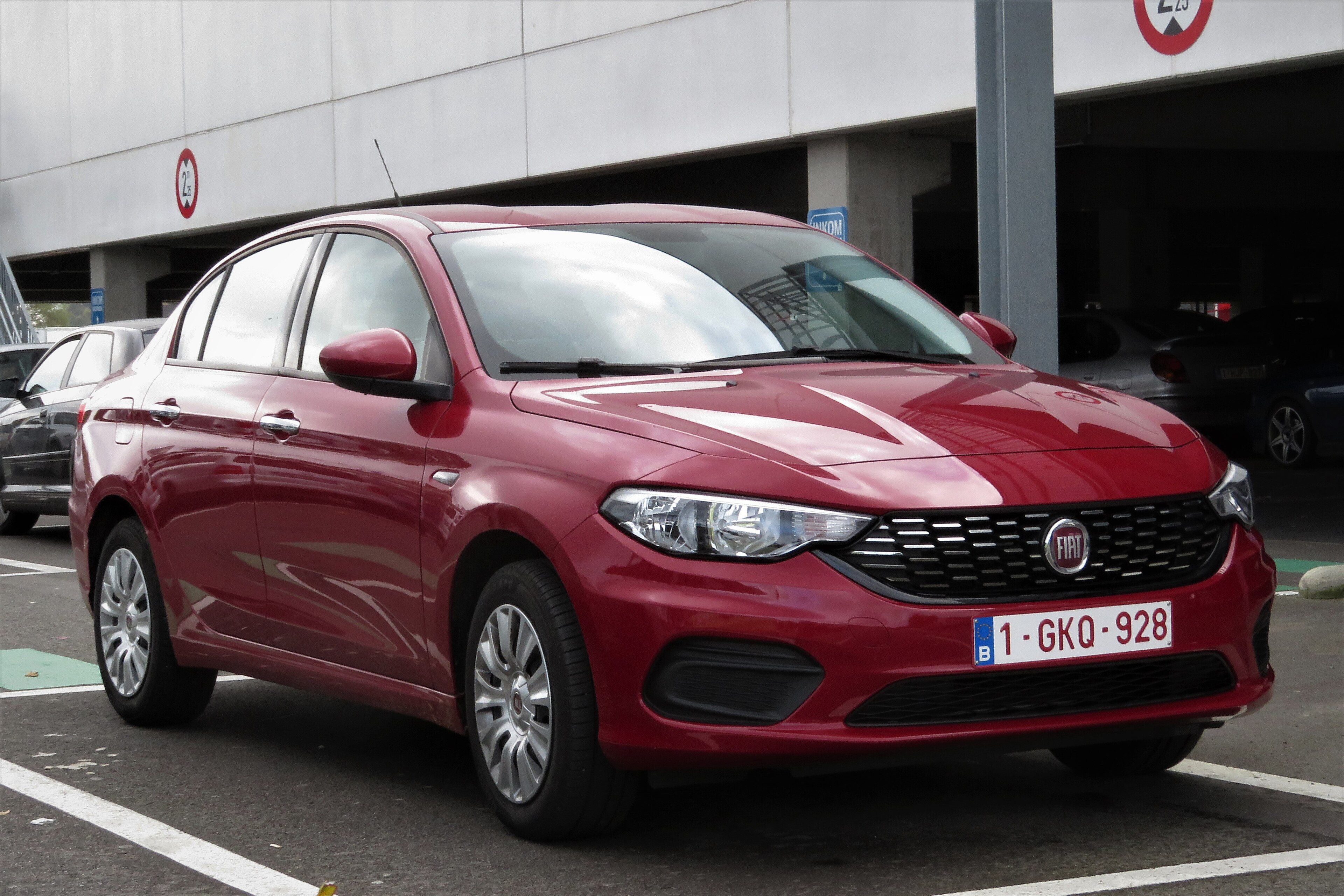 Red Fiat Tipo (Egea) four-door sedan, front three-quarter view