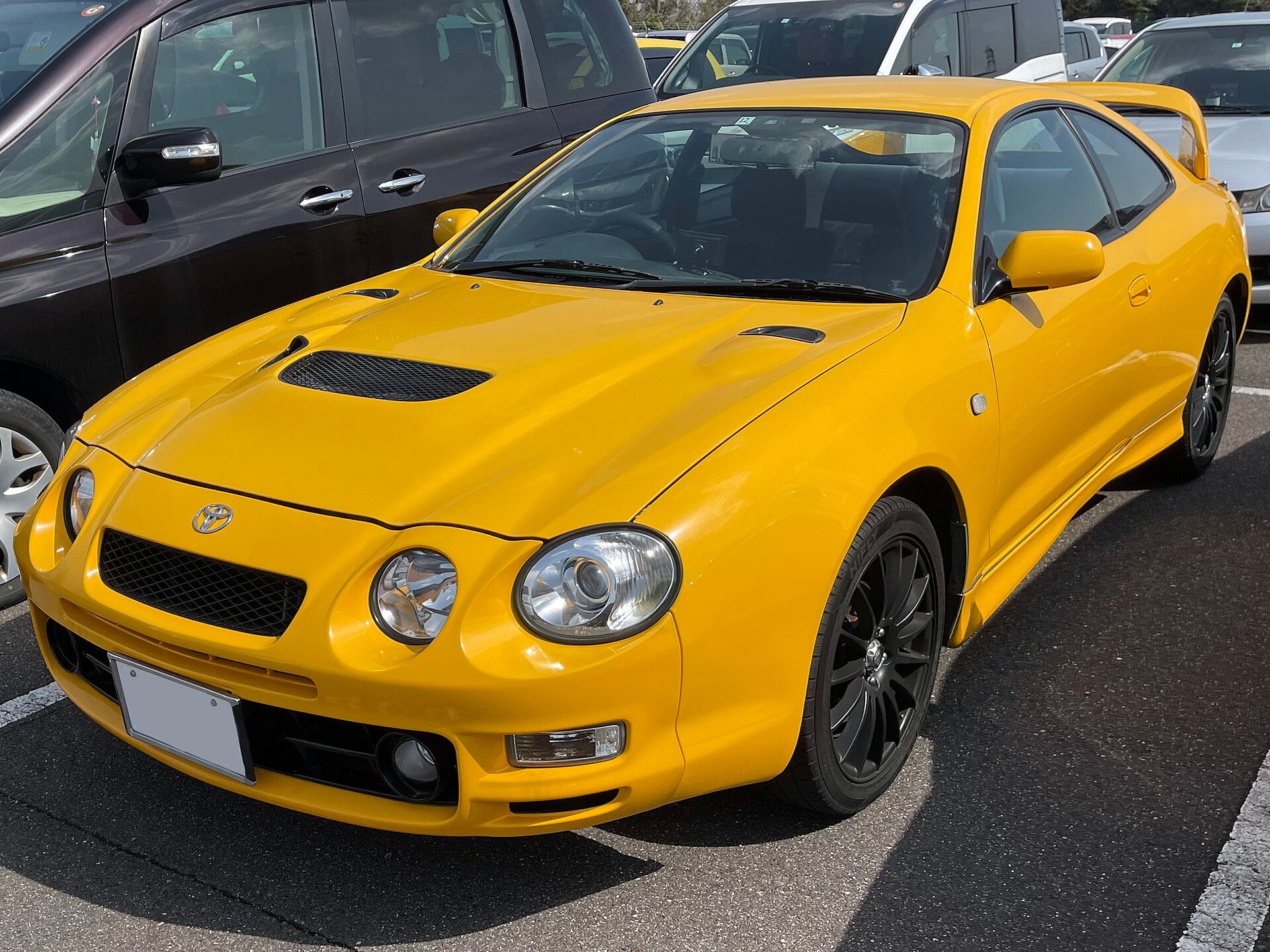 Yellow sixth-generation (T200) Toyota Celica GT-Four coupe, front three-quarter view