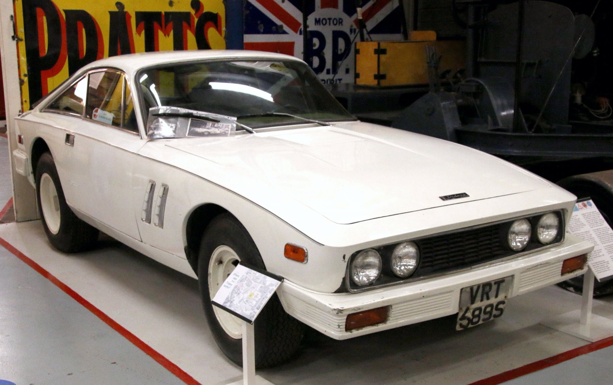 White 1976 Trident Clipper V8 fastback coupe on museum display, front three-quarter view