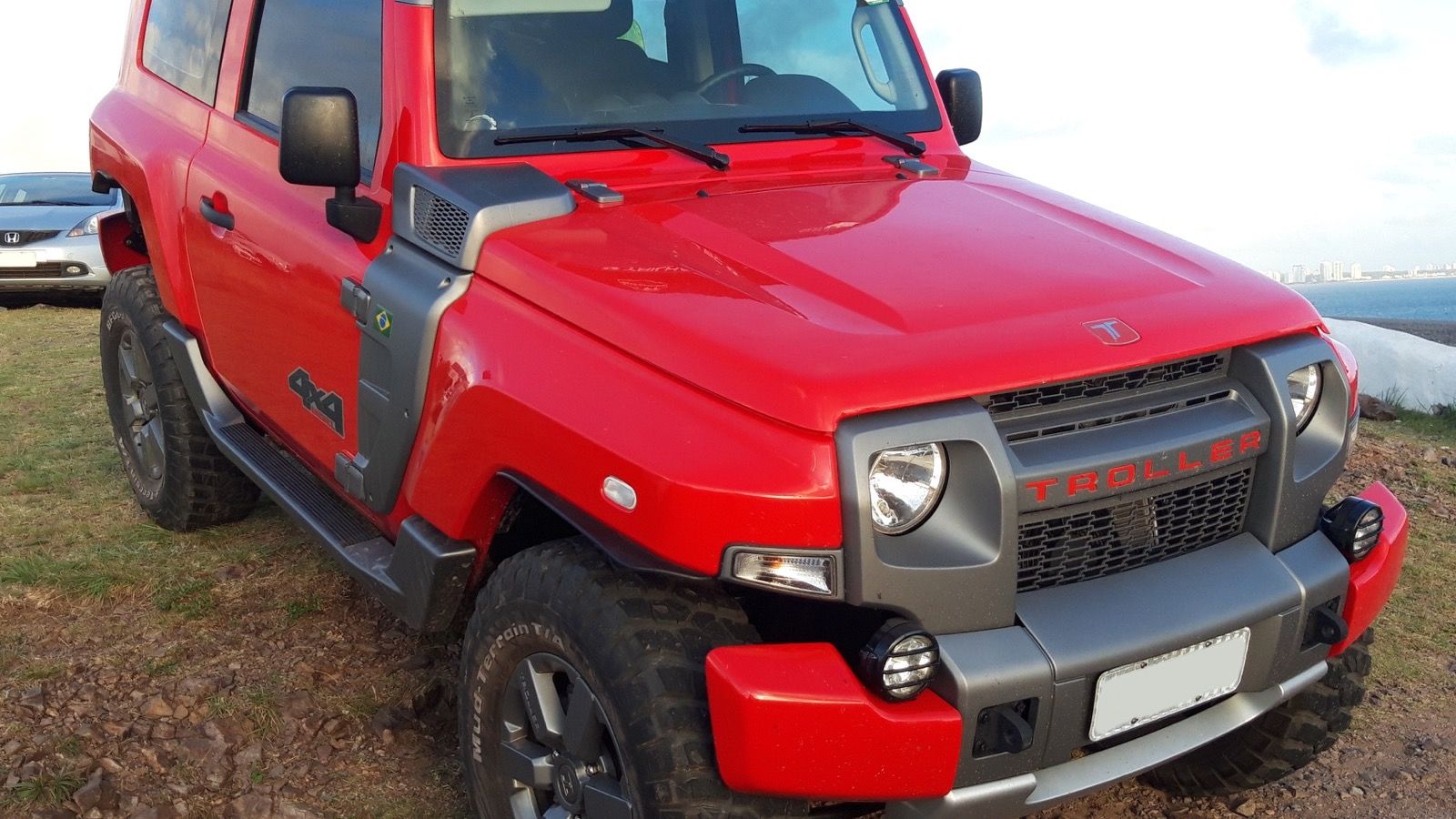 Red third-generation Troller T4 off-roader, front three-quarter view