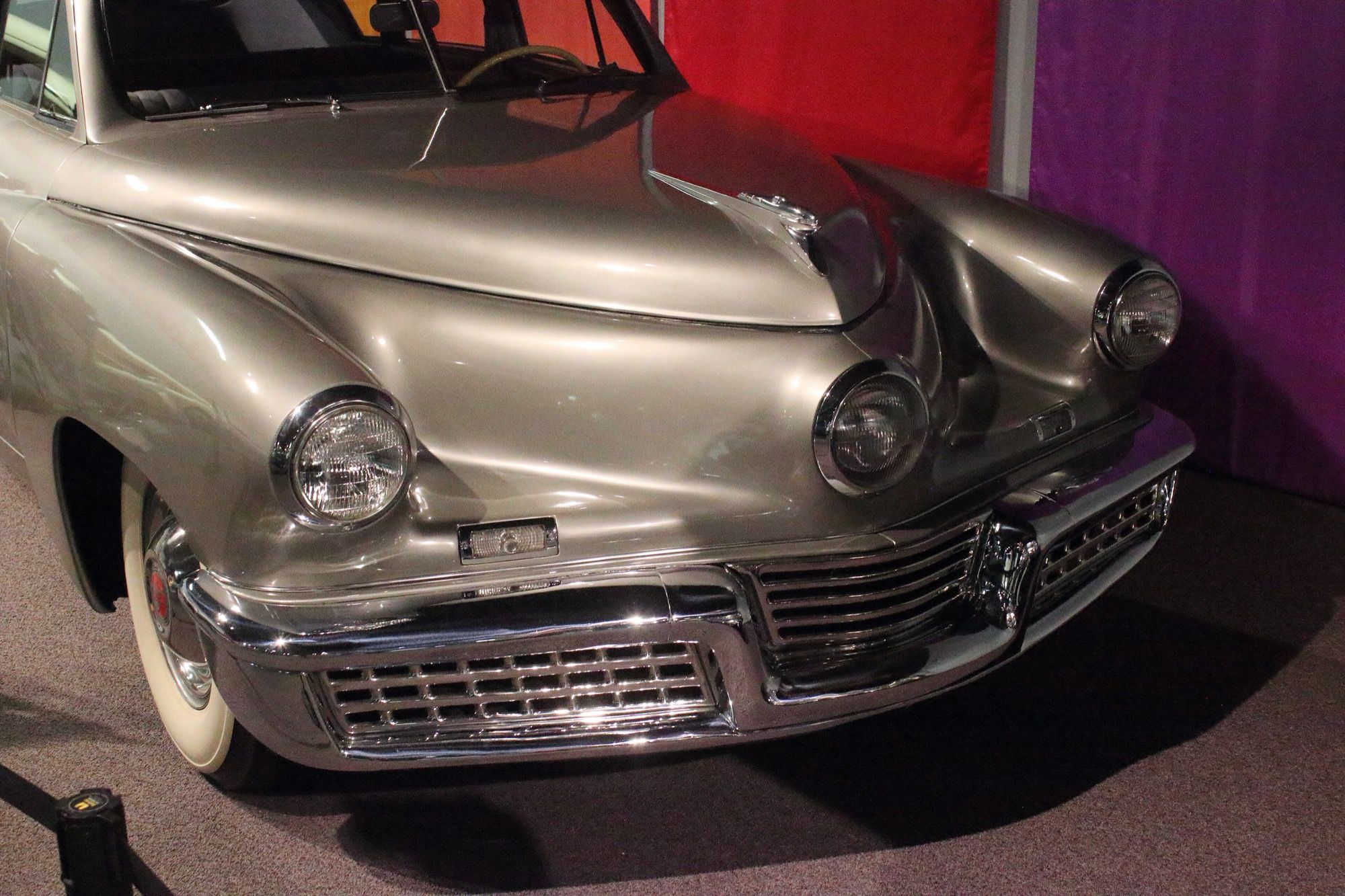 Grey 1948 Tucker 48 rear-engined fastback sedan, front three-quarter view