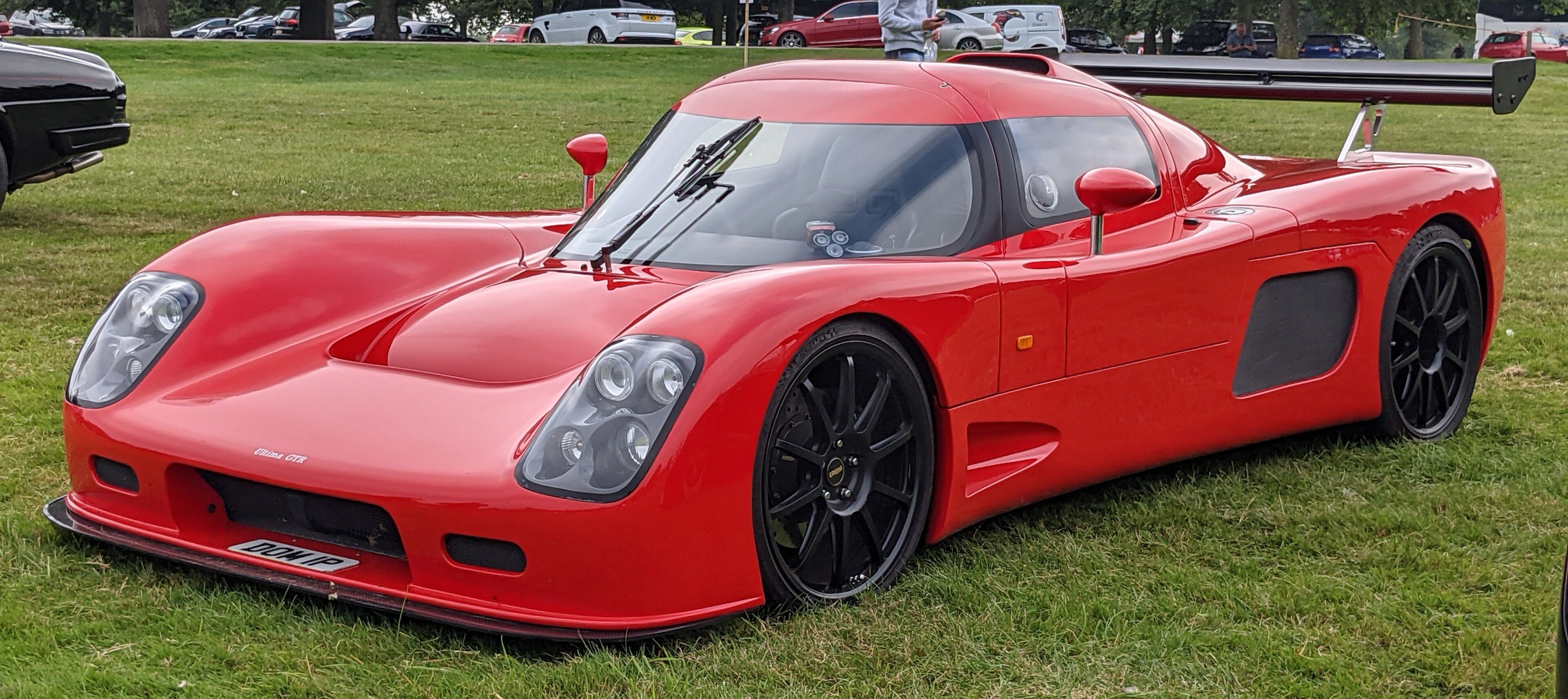Red 2010 Ultima GTR 7.0 with rear wing, front three-quarter view